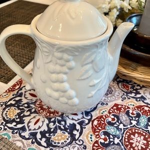 White teapot/coffeepot with decorative fruit.